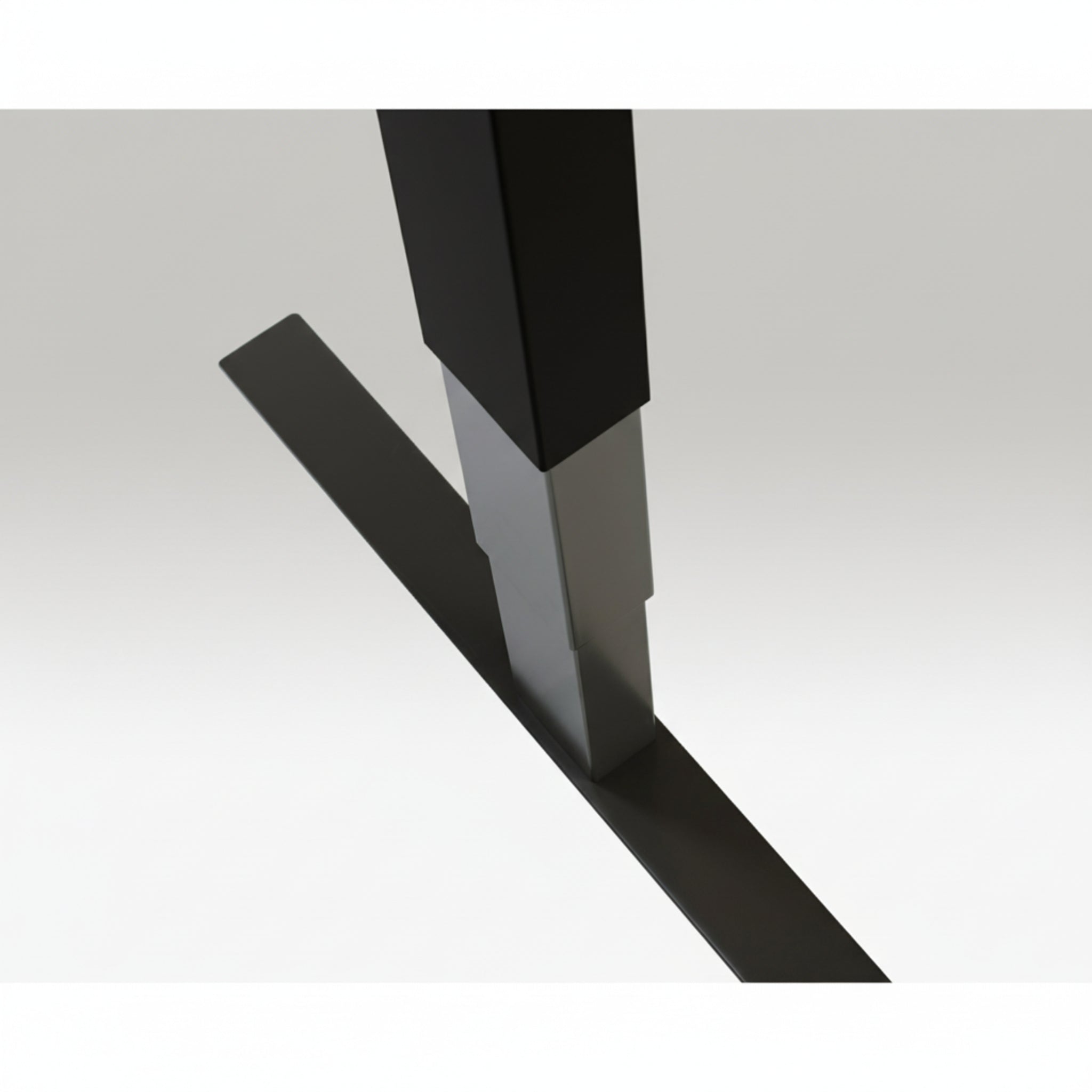 Close-up of Quiet Motor Standing Desk black frame showing top leg join and metallic finish detail