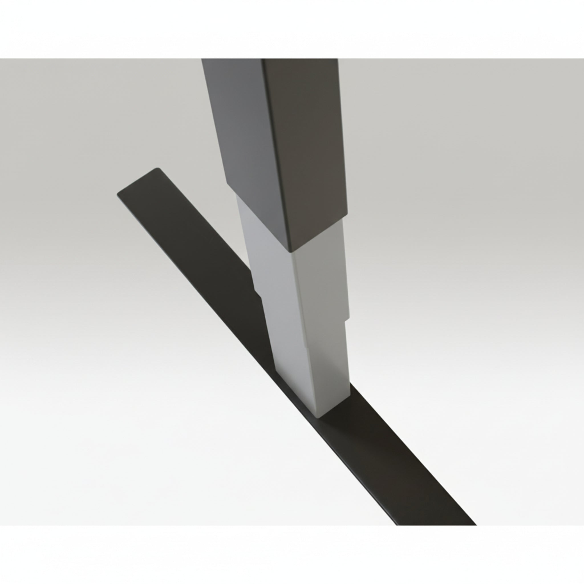 Close-up of Quiet Motor Standing Desk raw steel frame showing top leg join and metallic finish detail