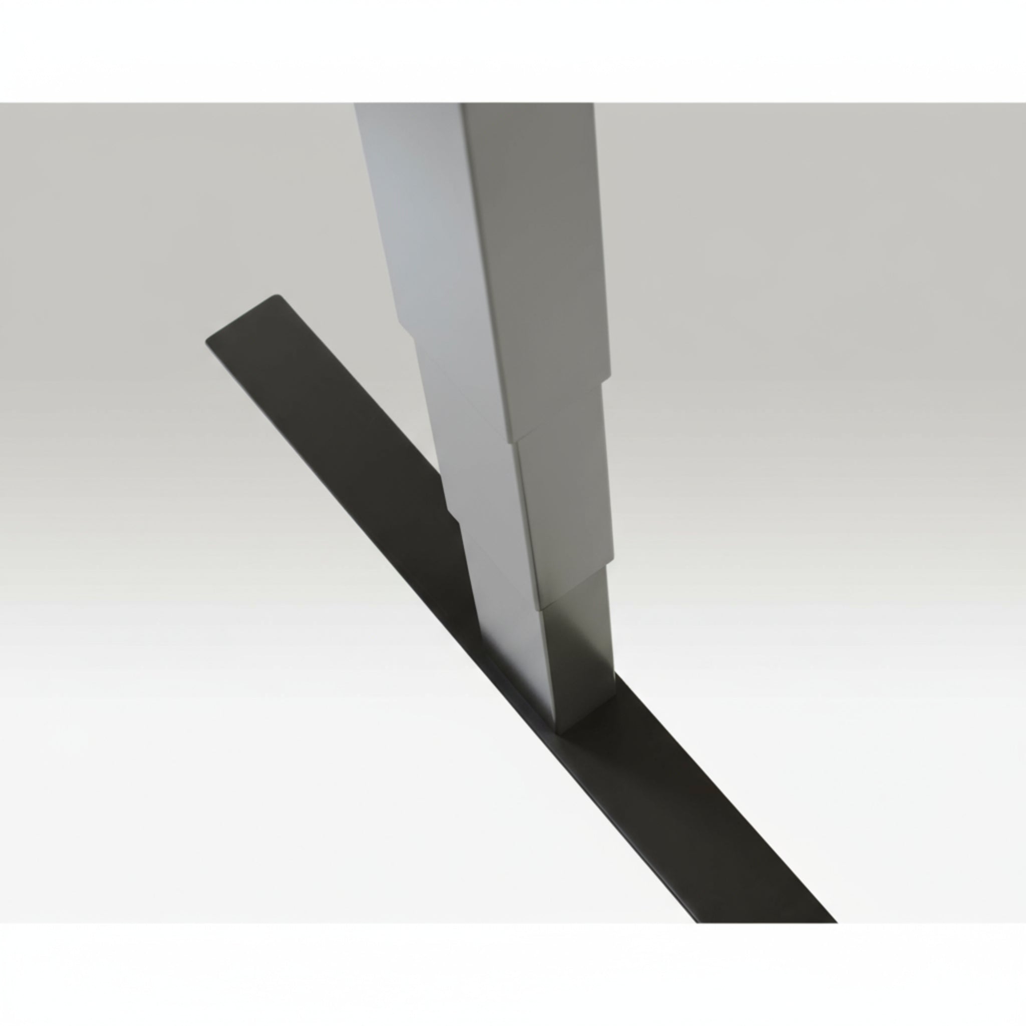 Close-up of Quiet Motor Standing Desk silver frame showing top leg join and metallic finish detail