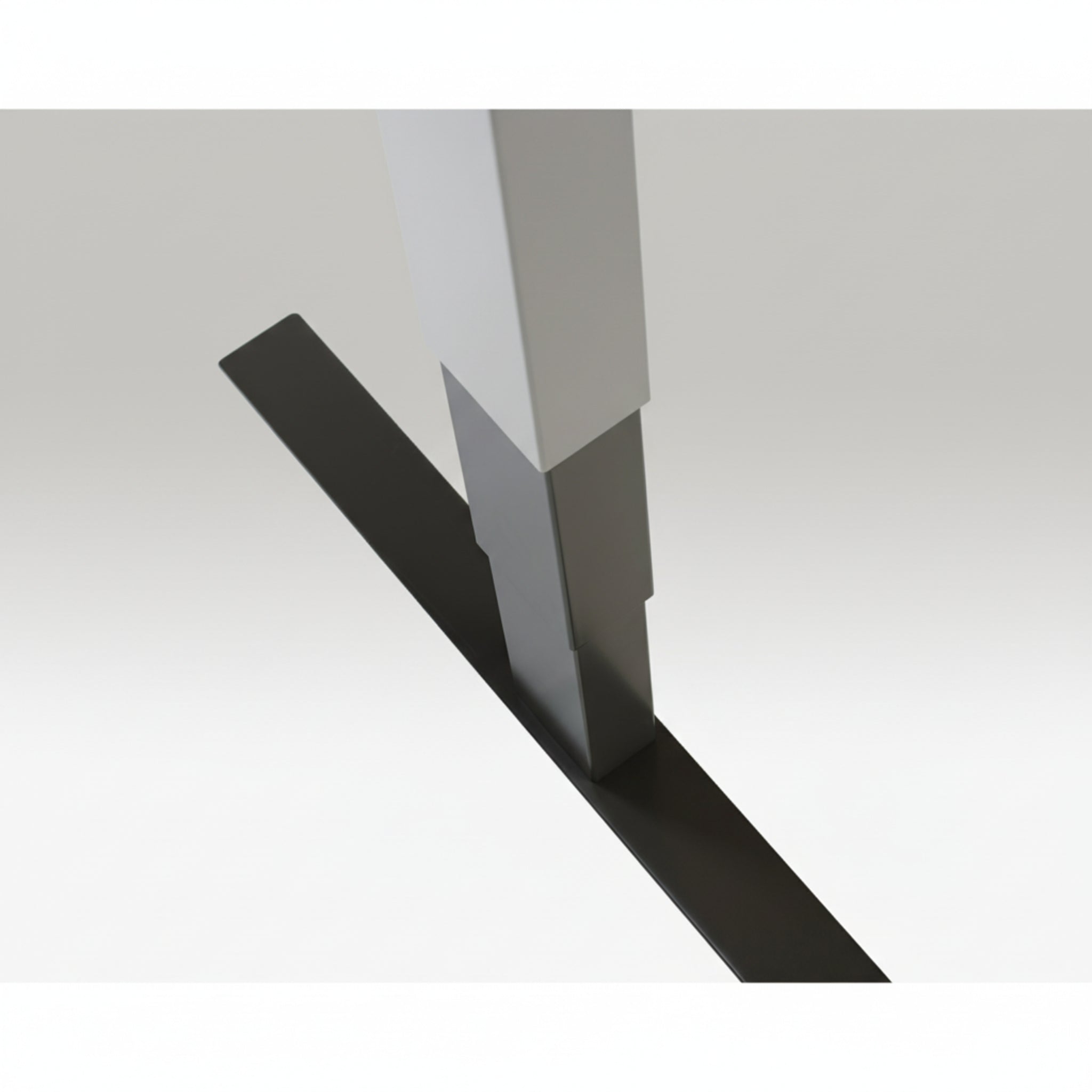 Close-up of Quiet Motor Standing Desk light grey frame showing top leg join and metallic finish detail
