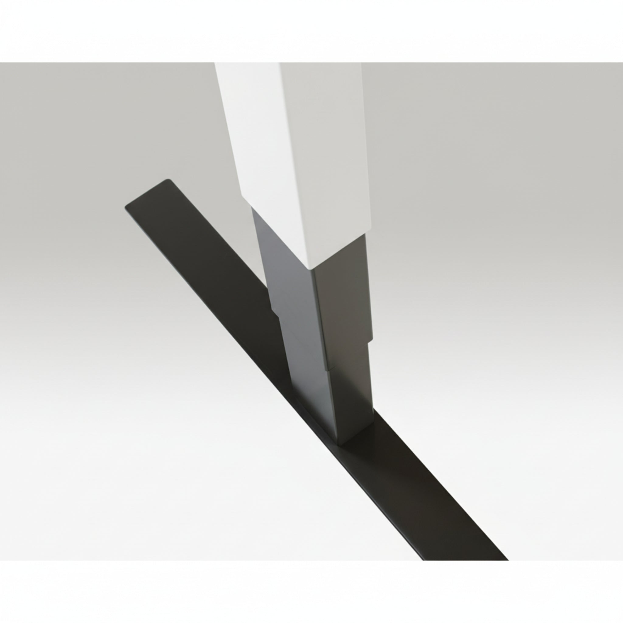Close-up of Quiet Motor Standing Desk white frame showing top leg join and metallic finish detail