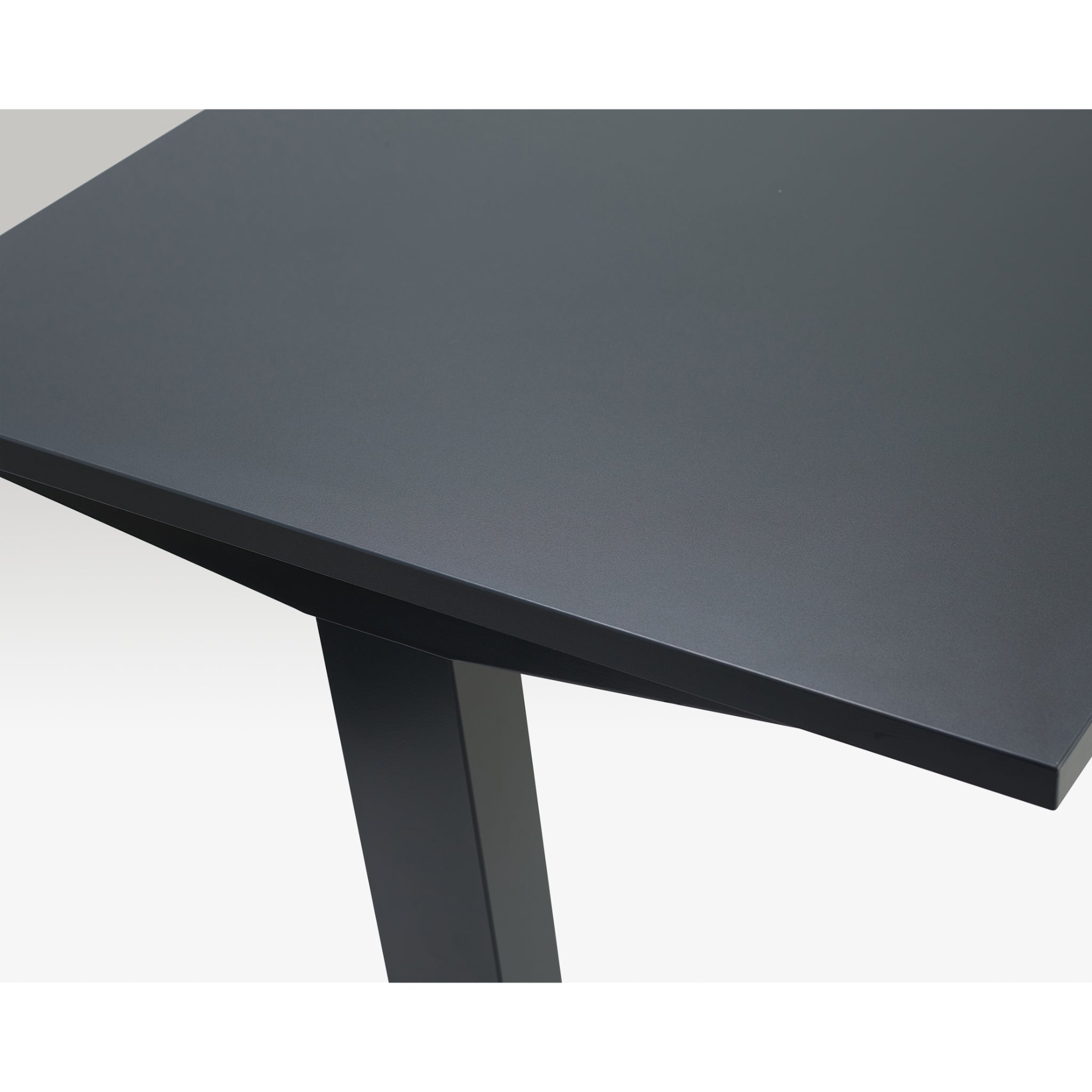 Close-up of Quiet Motor Standing Desk dark metal desktop and top of leg with anthracite finish