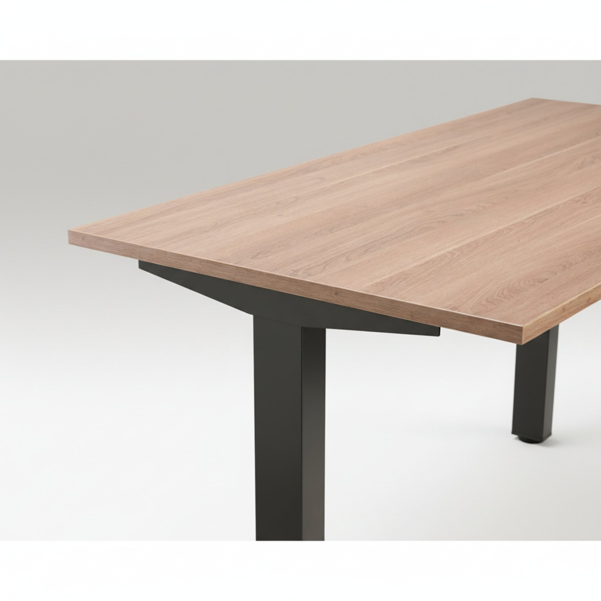 Close-up of Quiet Motor Standing Desk with wooden desktop and black metal leg