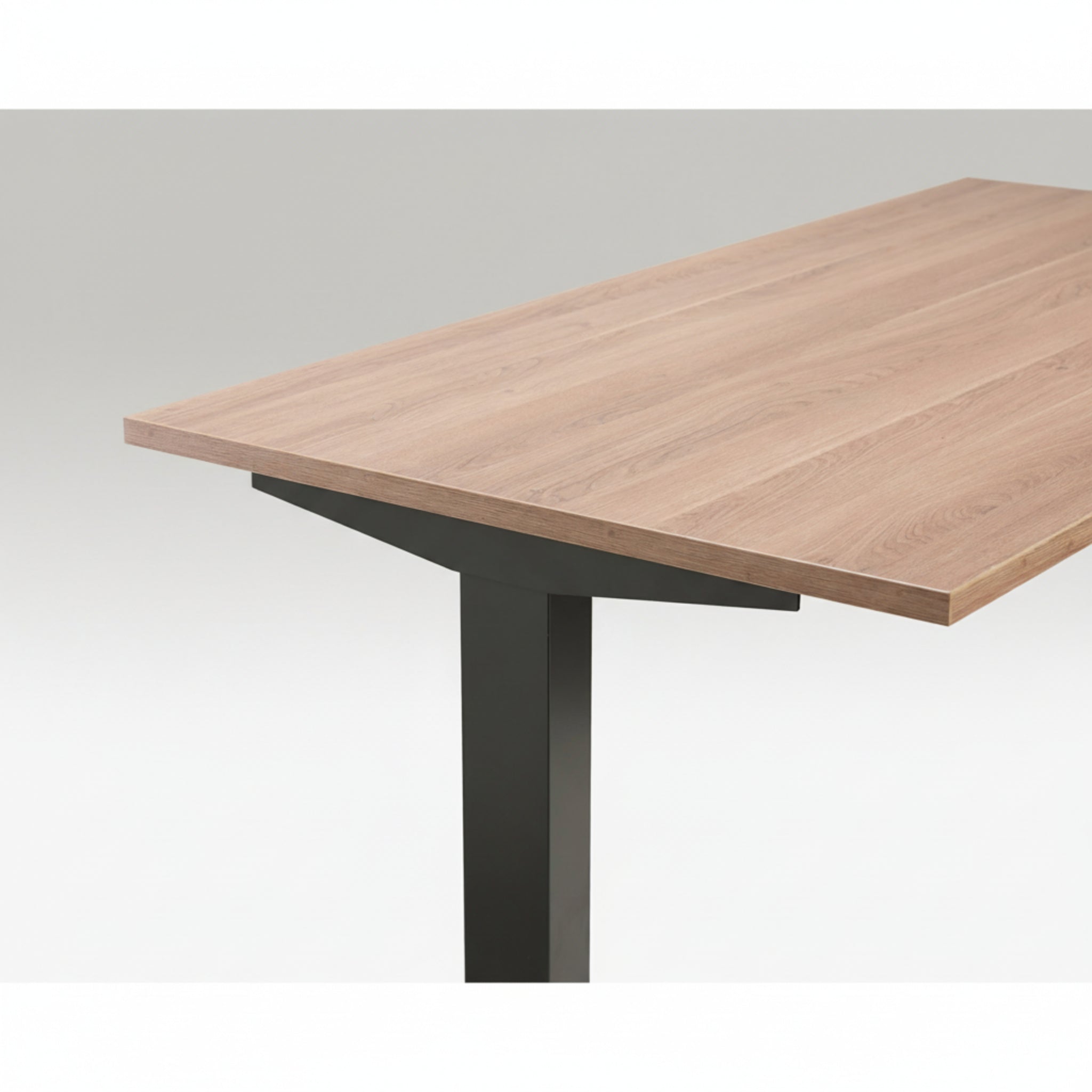 Close-up of Quiet Motor Standing Desk with wooden desktop and dark grey metal leg