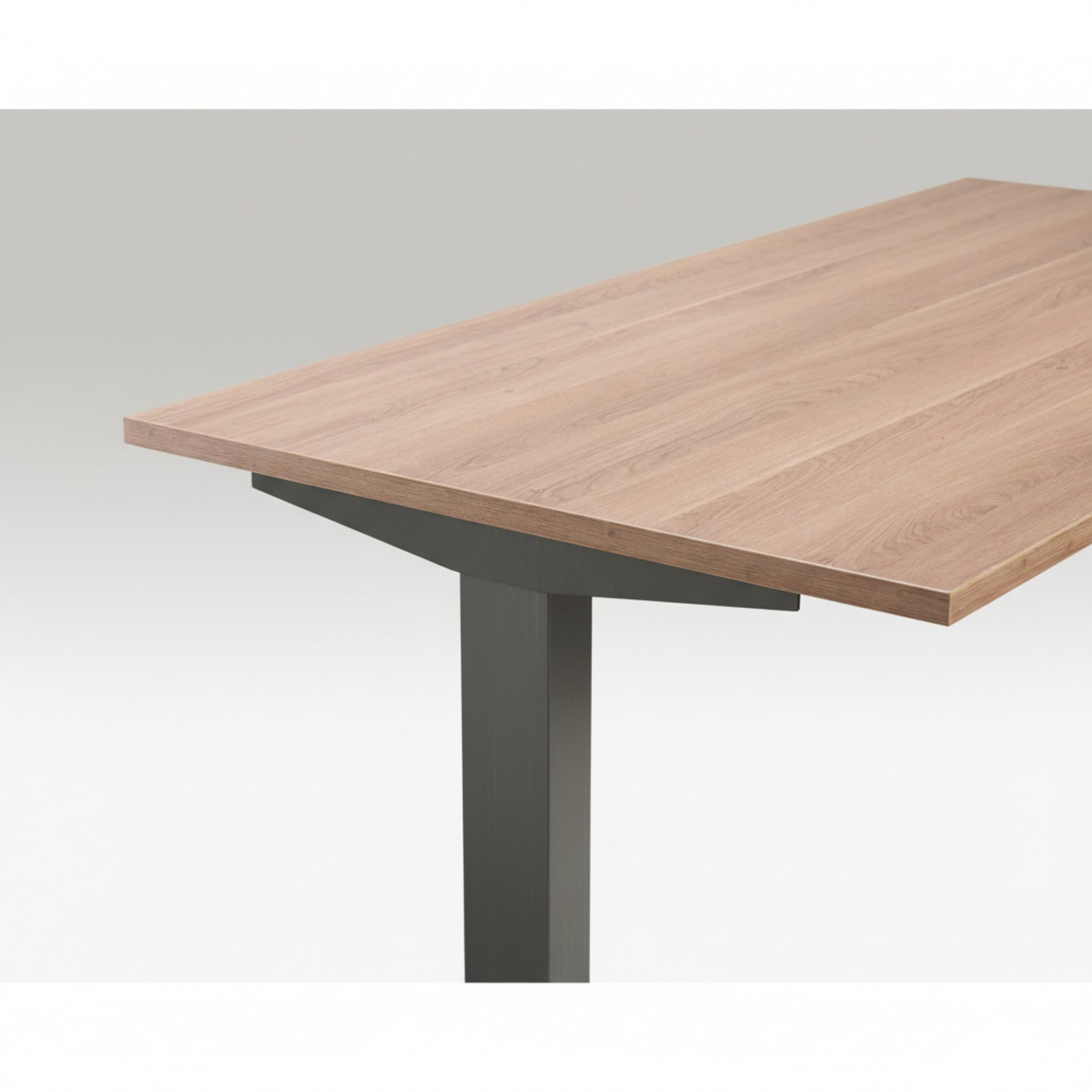 Close-up of Quiet Motor Standing Desk with wooden desktop and raw steel metal leg