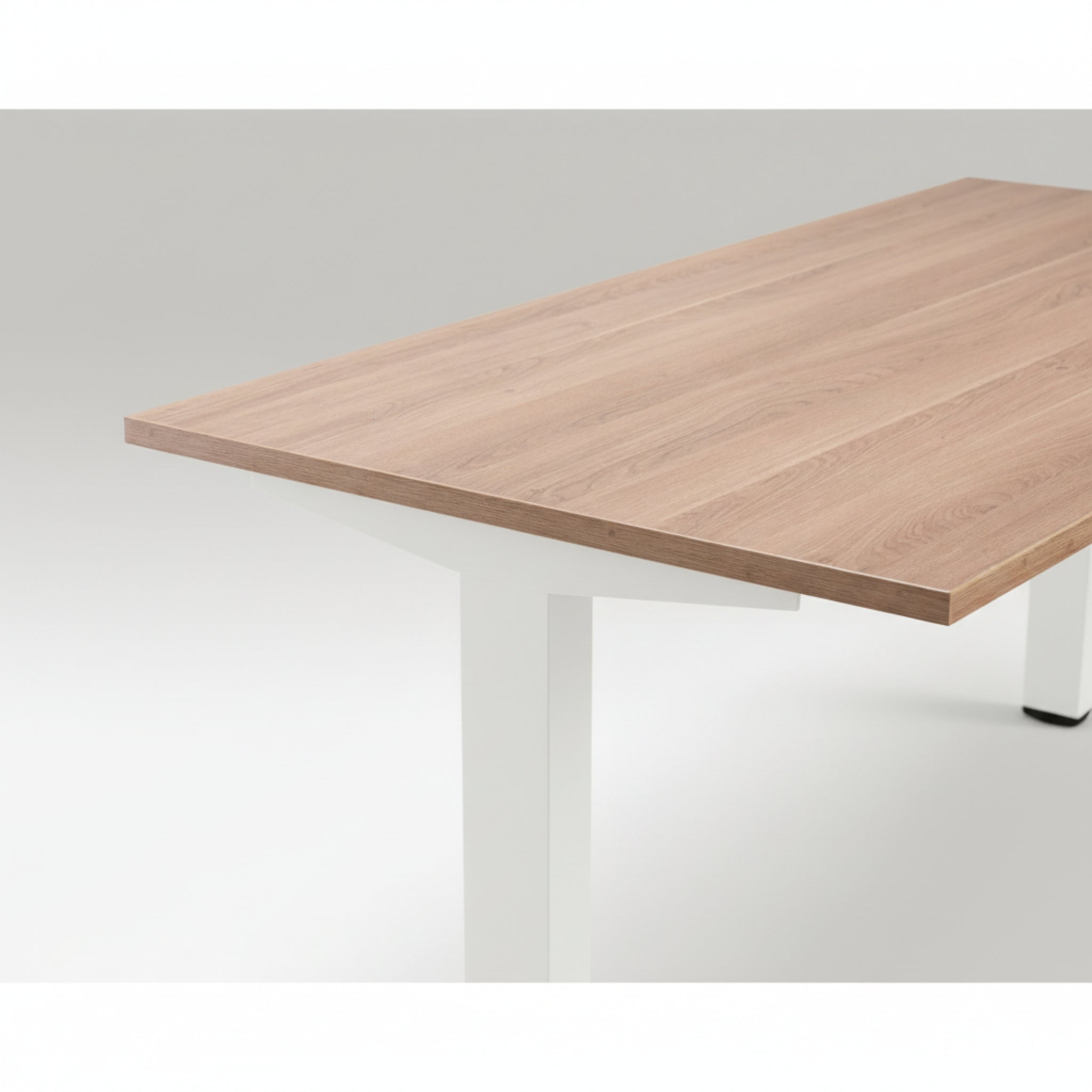 Close-up of Quiet Motor Standing Desk with wooden desktop and white metal leg