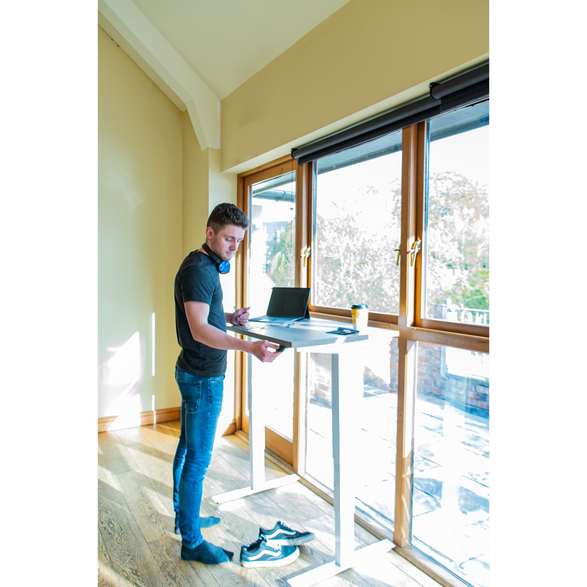 Zoomed out view of white frame controls on a compact standing desk