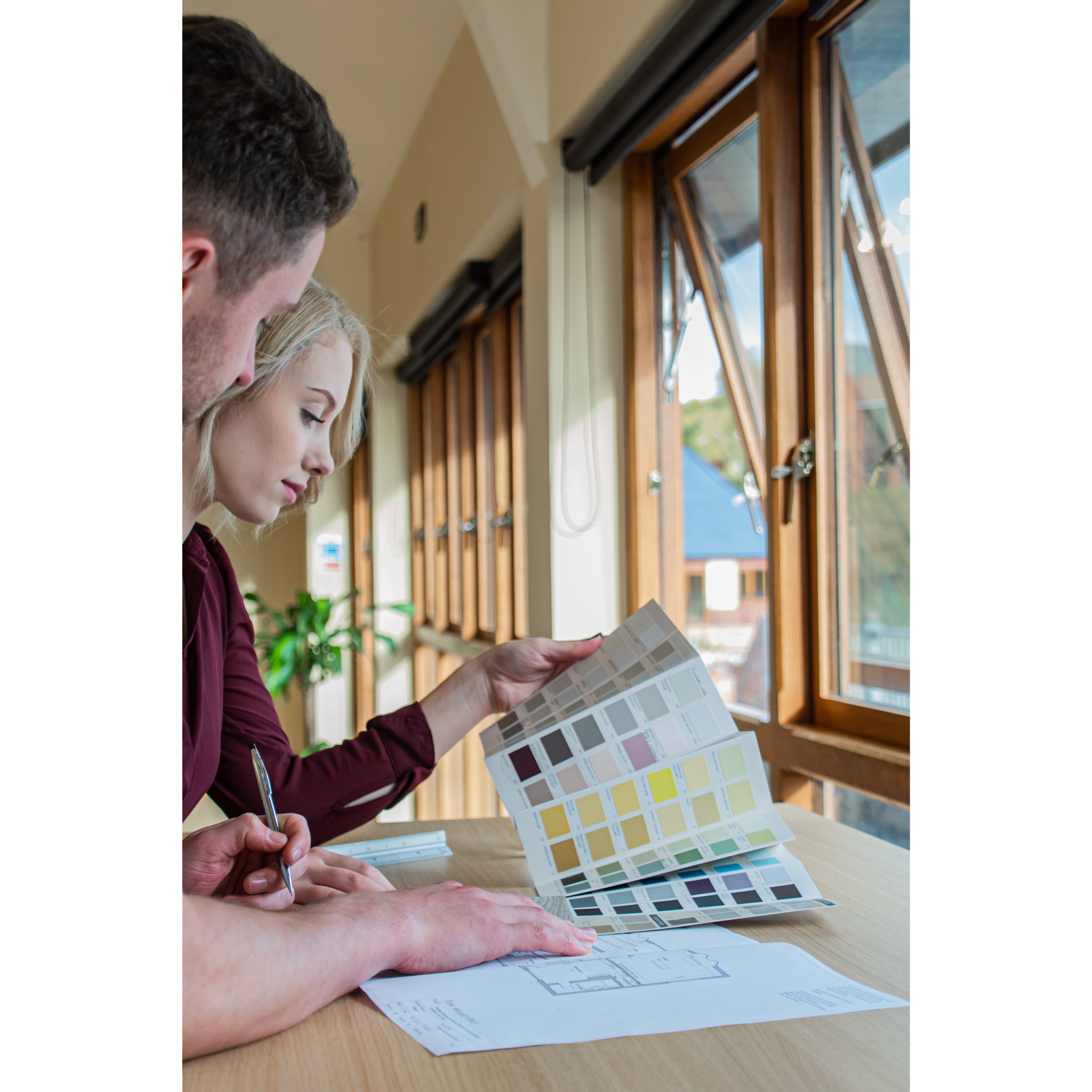 Two people working together at the UrbanErgo Signature sit-stand desk