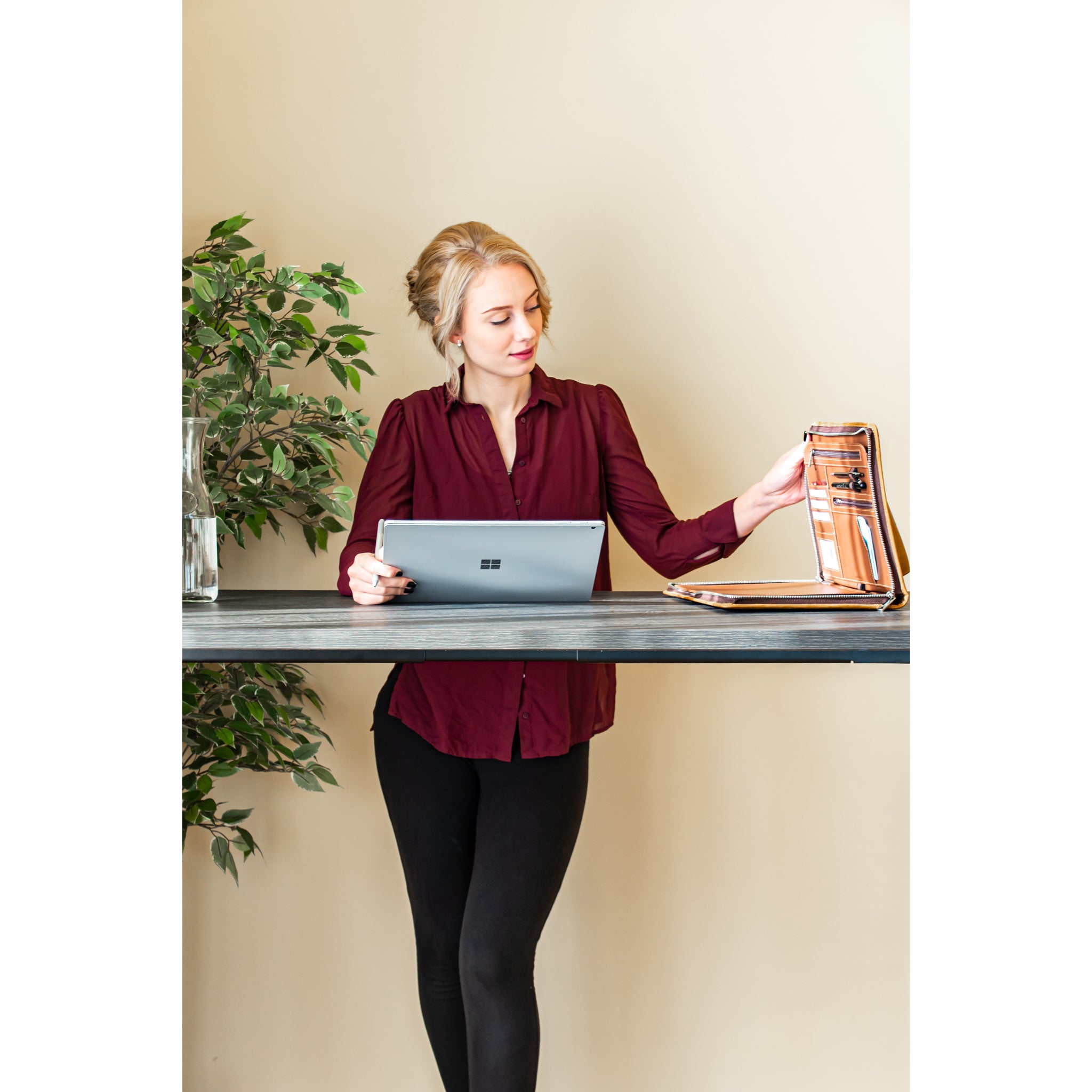 Person using a laptop at the UrbanErgo Signature electric standing desk